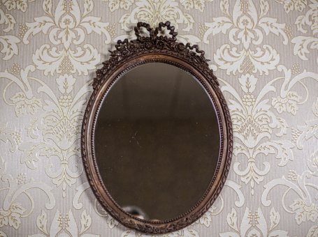 Oval Mirror in a Stylized Frame